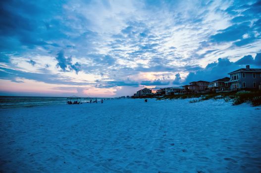 sunset on florida beach with white sand and blue sky