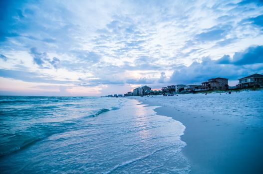 sunset on florida beach with white sand and blue sky