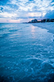 sunset on florida beach with white sand and blue sky