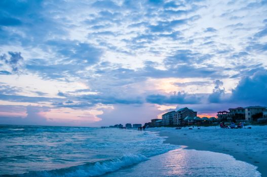 sunset on florida beach with white sand and blue sky