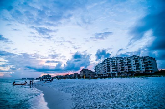 sunset on florida beach with white sand and blue sky