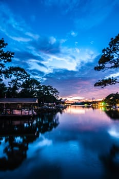 A Very Colorful Mythical Sunset Over water way near ocean