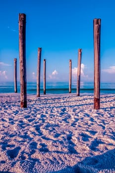 old sea pier ruins on the beach in the morning