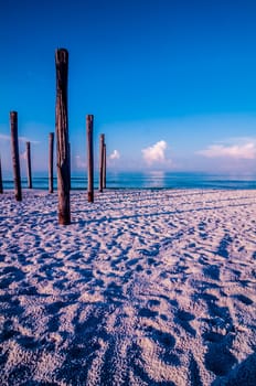 old sea pier ruins on the beach in the morning