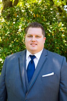 Portraits of a groom on his wedding day while waiting for his bride at a park outdoors in Oregon before the ceremony.