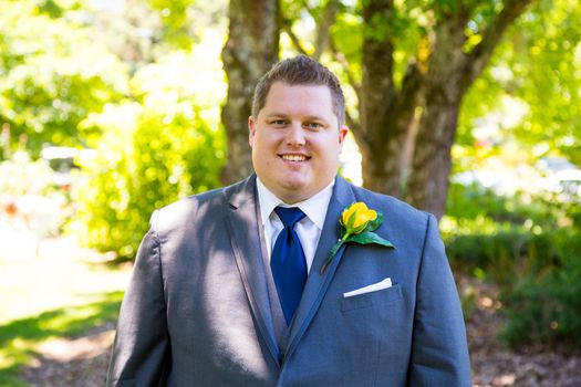 Portraits of a groom on his wedding day while waiting for his bride at a park outdoors in Oregon before the ceremony.