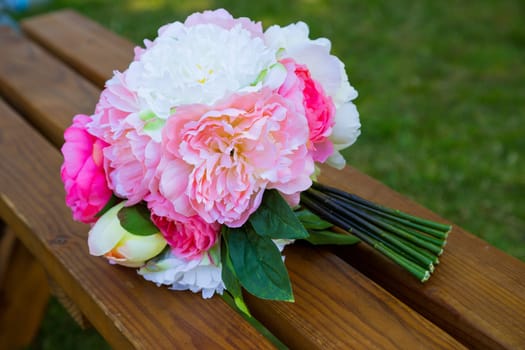 Flowers at a wedding ceremony celebration outdoors at a park.