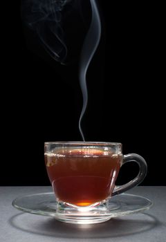 Hot tea in a glass cup with handle 
