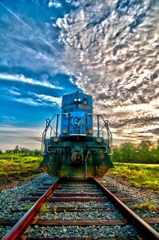 blue freight train engine at sunrise