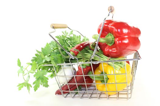 shopping basket with vegetables on a bright background