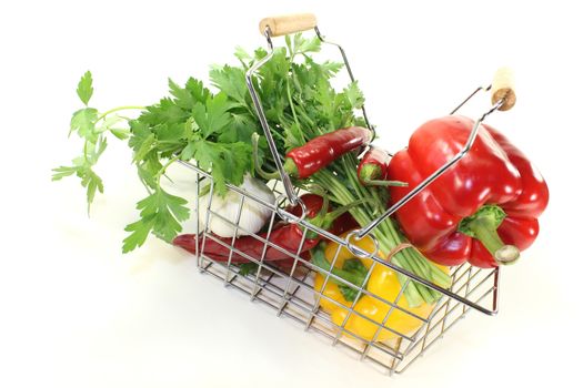 shopping basket with fresh vegetables on a bright background