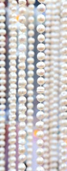 Many beads of pearls as ackground. Close-up.