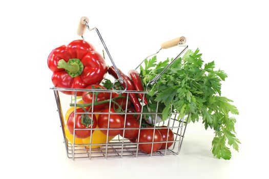 shopping basket with crisp vegetables on a bright background