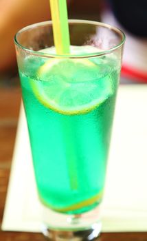 Cocktail with lime in wet glass. Close-up.