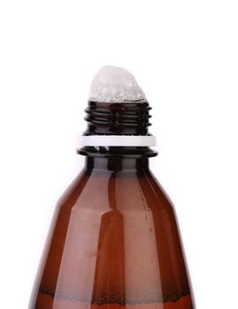 Froth cap of open beer bottle close-up on the white background