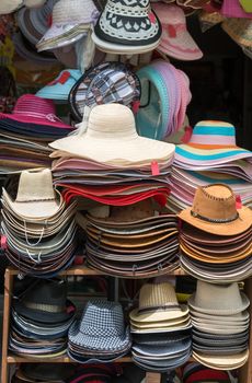 Varied fashion hats showcase on open market shop 