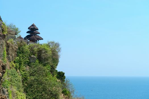 Pura Luhur Uluwatu Temple, Bali on high rock above blue tropical sea