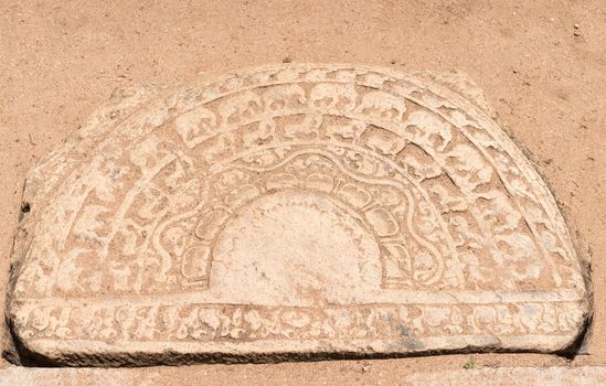 Ancient ground carving at the entrance is a moon stone (sandakada pahana) symbolises the cycle of Samsara in Buddhism, Polonnaruwa, Sri Lanka