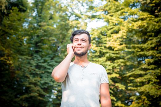 stylish man on the phone at the park