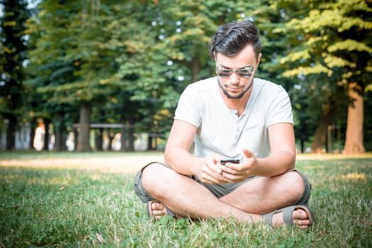 stylish man on the phone at the park