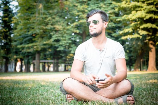 stylish man on the phone at the park