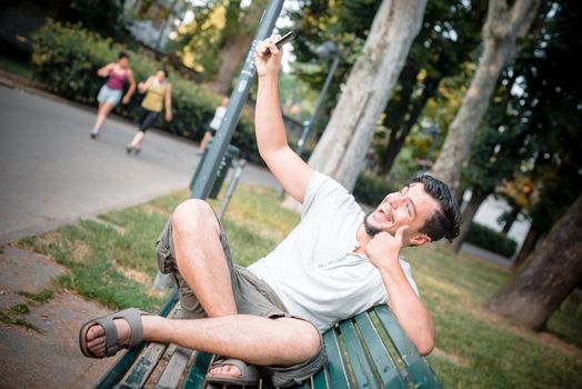 stylish man on the phone at the park