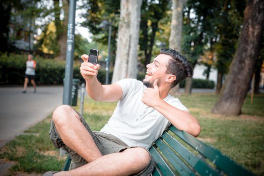 stylish man on the phone at the park