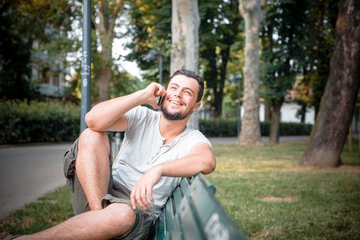 stylish man on the phone at the park