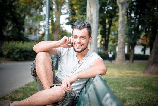 stylish man on the phone at the park