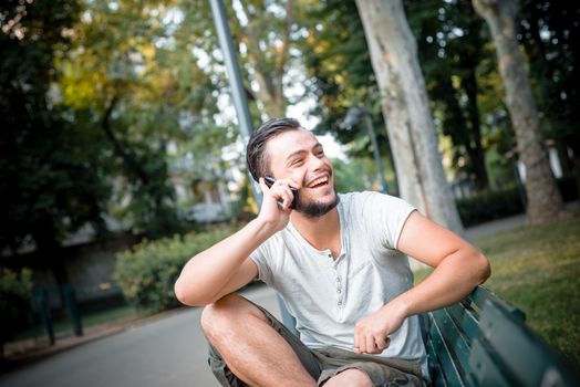 stylish man on the phone at the park