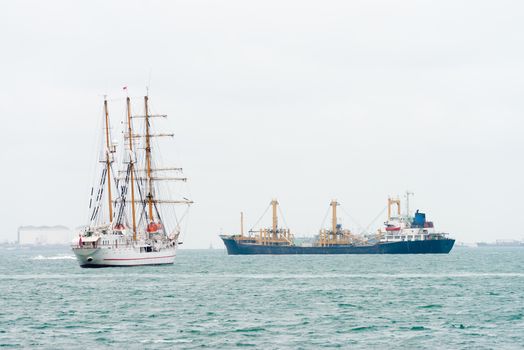 Sailing vessel ship and oil tanker on the sea near a port