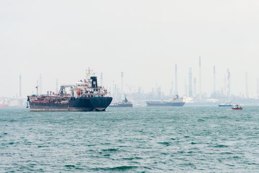 Oi tanker on the sea near a port and oil-processing center, Singapore