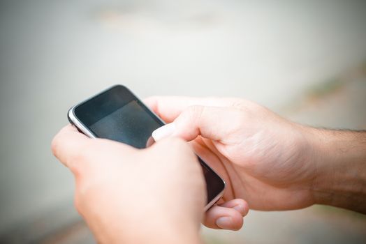 hand with smartphone typing