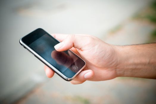 hand with smartphone typing