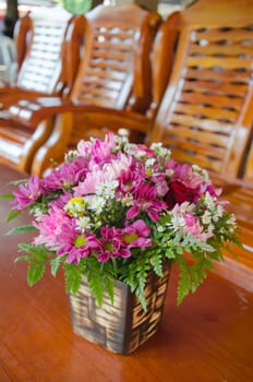  fresh  flowers in vase  on wooden table