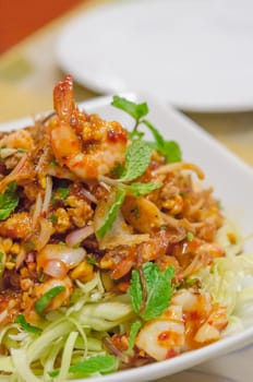 Spicy shrimp on a salad with eggs and minced pork