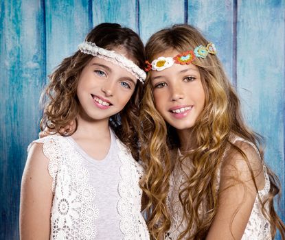 Children friends beautiful girls hippie retro style smiling together on blue wood