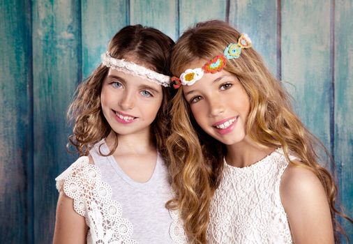 Children friends beautiful girls hippie retro style smiling together on blue wood vintage color