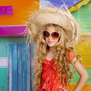 blond children happy tourist girl with straw beach hat and sunglasses on a tropical house