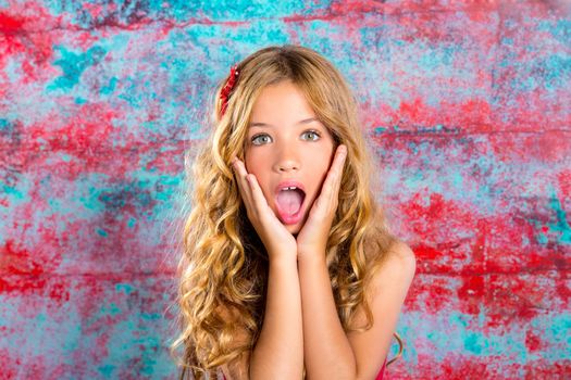 Blond kid girl surprised expression hands in face gesture