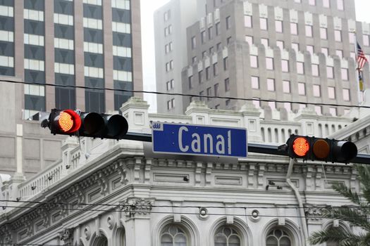 Canal Street stoplight with buildings in the background