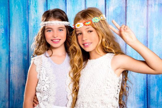 Children friends beautiful girls hippie retro style smiling together on blue wood