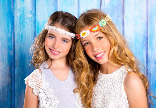 Children friends beautiful girls hippie retro style smiling together on blue wood