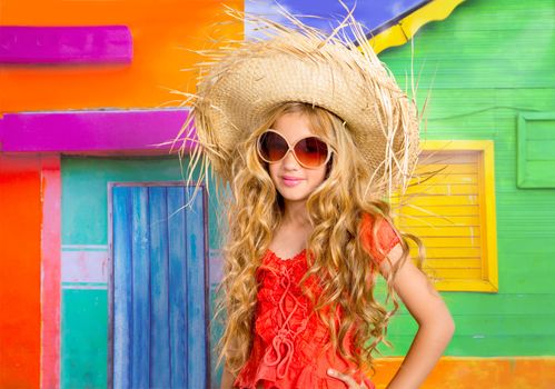 blond children happy tourist girl with straw beach hat and sunglasses on a tropical house
