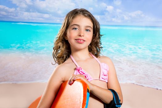 Children fashion surfer girl in tropical turquoise beach vacation smiling