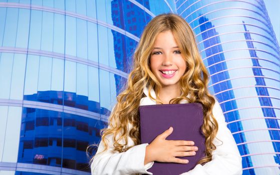 Children business student girl with tablet pc on urban blue buidings background