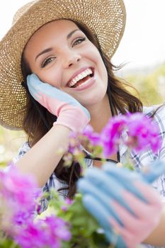 Attractive Happy Young Adult Woman Wearing Hat Gardening Outdoors.