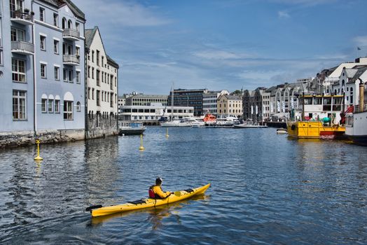 Aalesund harbor, Norway with a yellow kayak in the foreground