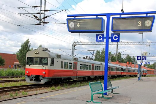 Regional train on an empty platform at a railway station.