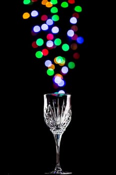 Beautiful light bokeh bubbles coming out of a wine glass